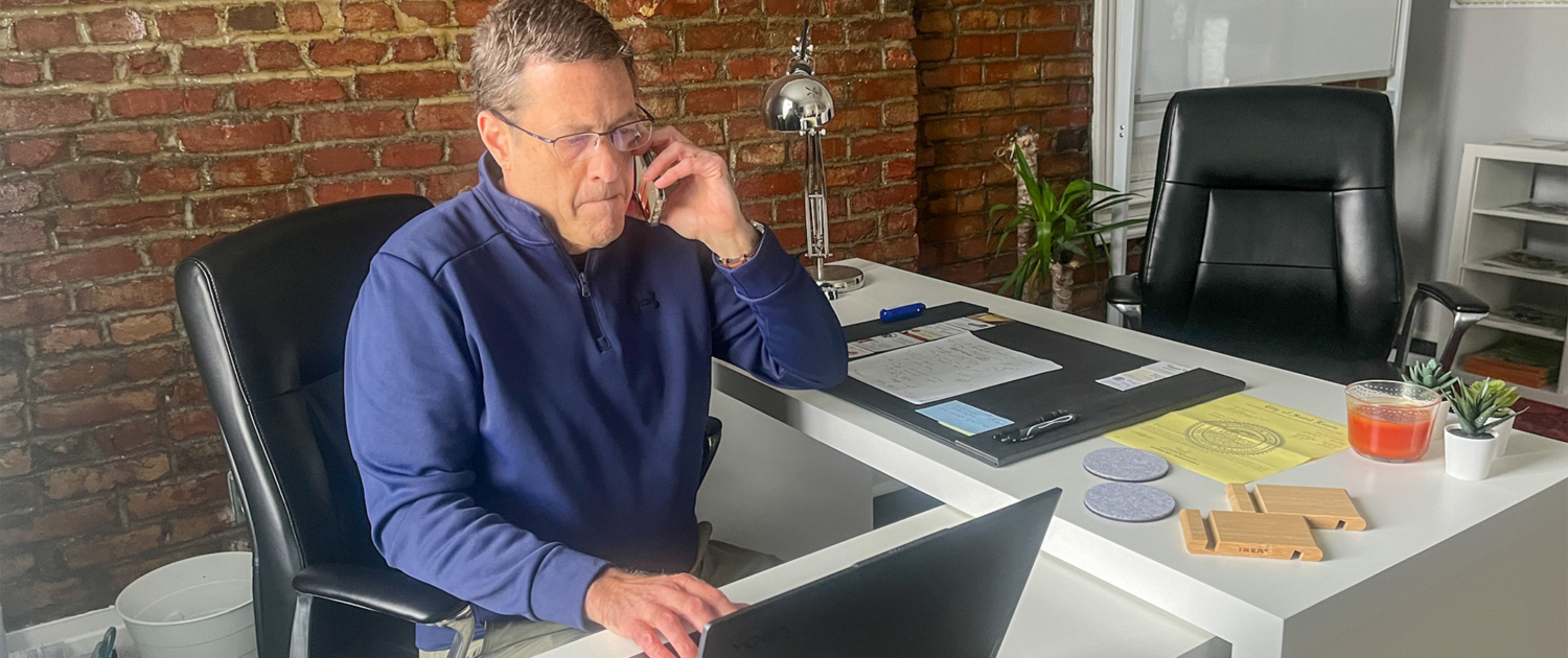 Man Using Laptop And Taking Phonecall